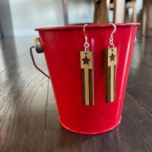Load image into Gallery viewer, Rectangle Star &amp; Stripes wood earrings hanging on red bucket
