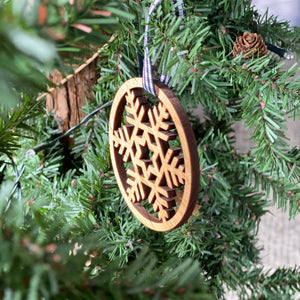 Snowflake Wood Ornament hanging on tree